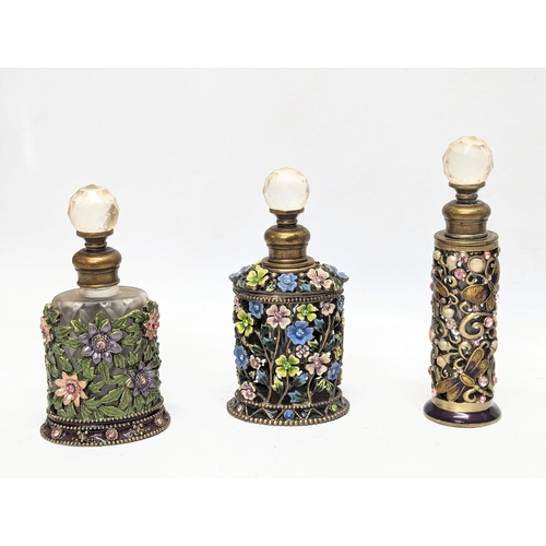 472 - A collection of ornate scent bottles / perfume bottles.