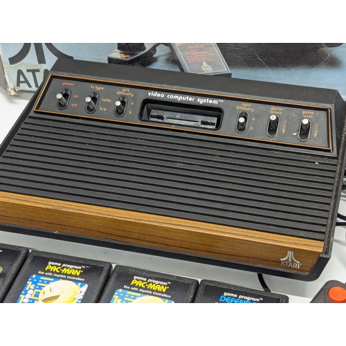 536 - A vintage Atari Video Computer System with 2 remote controllers, including games (Pac-Man, Space Inv... 