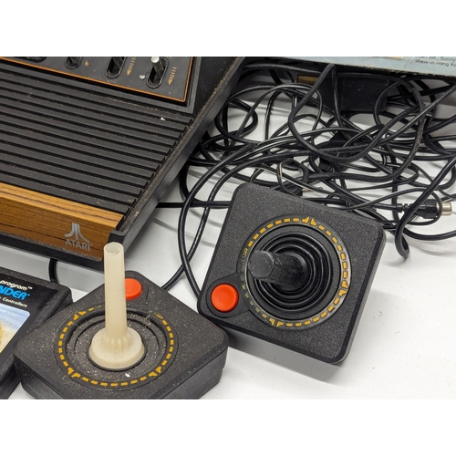 536 - A vintage Atari Video Computer System with 2 remote controllers, including games (Pac-Man, Space Inv... 