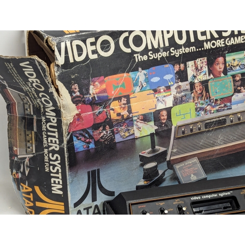 536 - A vintage Atari Video Computer System with 2 remote controllers, including games (Pac-Man, Space Inv... 