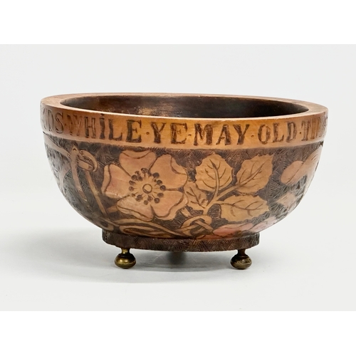 276 - An early 20th century Irish Pokerwork bowl on brass feet. Gather ye Rosebuds While Ye May Old Time I... 