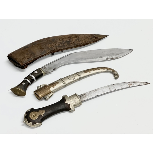 401 - A vintage steel bladed Kindjal dagger with wooden handle and scabbard. Together with a Gurkha style ... 