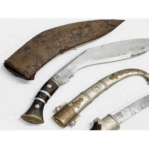 401 - A vintage steel bladed Kindjal dagger with wooden handle and scabbard. Together with a Gurkha style ... 