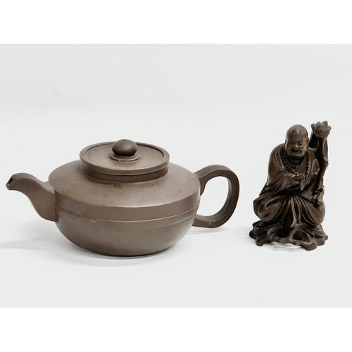 478 - An early 20th century Chinese Yixing teapot and a small figure.