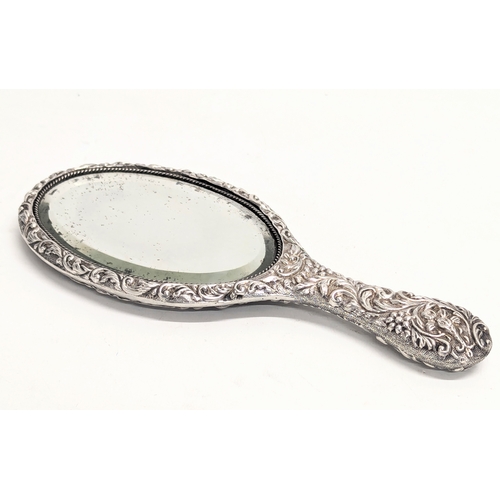 560 - A late 19th century ornate silver vanity mirror by Joseph Gloster. Birmingham, 1897. 25.5cm