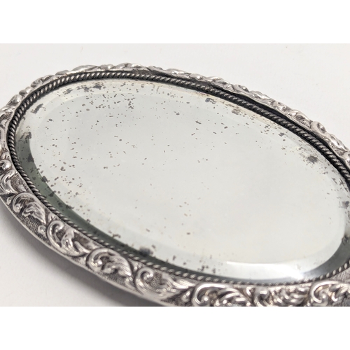 560 - A late 19th century ornate silver vanity mirror by Joseph Gloster. Birmingham, 1897. 25.5cm