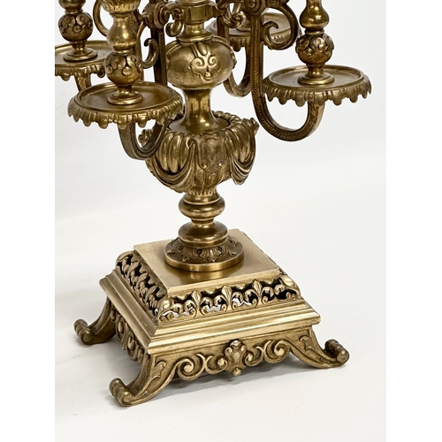 16 - A pair of good quality early 20th century brass candelabrums with pierced bases and draped urn style... 