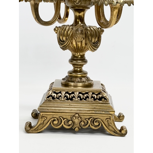 16 - A pair of good quality early 20th century brass candelabrums with pierced bases and draped urn style... 