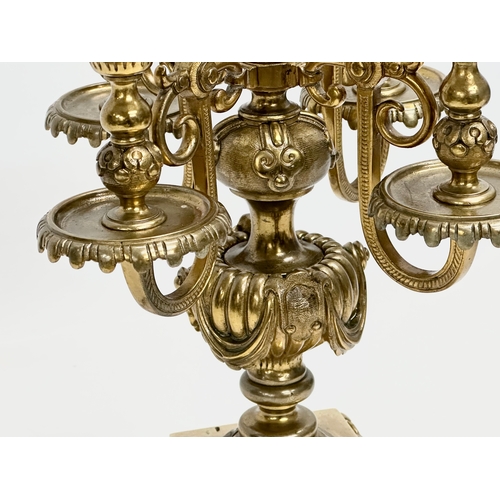 16 - A pair of good quality early 20th century brass candelabrums with pierced bases and draped urn style... 