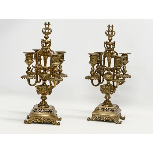 16 - A pair of good quality early 20th century brass candelabrums with pierced bases and draped urn style... 