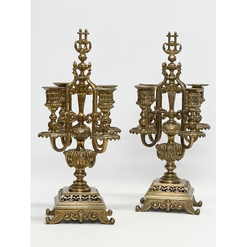 16 - A pair of good quality early 20th century brass candelabrums with pierced bases and draped urn style... 