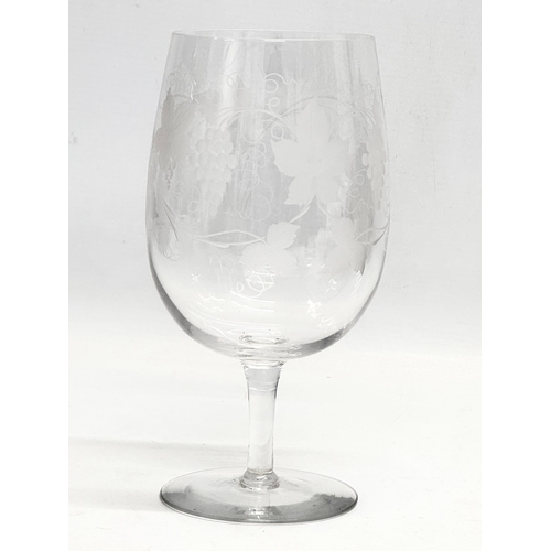 59 - A large early 19th century drinking glass with etched leaves and grape vines. Circa 1800-1840. 10x21... 