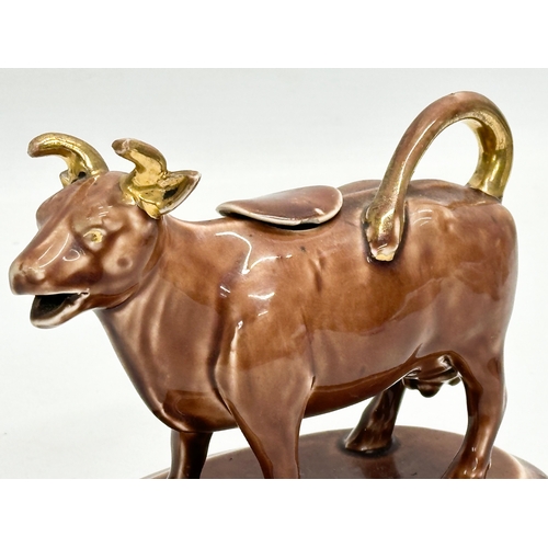 24A - A late 19th century/early 20th century brown pottery Cow Creamer. 16x9x12cm