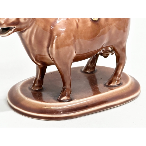 24A - A late 19th century/early 20th century brown pottery Cow Creamer. 16x9x12cm