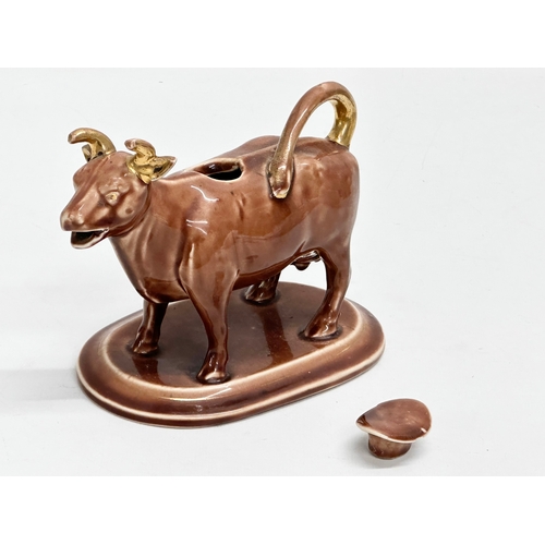 24A - A late 19th century/early 20th century brown pottery Cow Creamer. 16x9x12cm