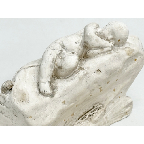 60 - A Lorna Adamson ‘Cupid Asleep’ figure. Dated 1911. 16x7x9.5cm