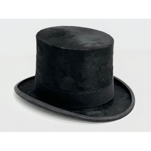 112 - A Victorian top hat with leather hat box. Very Best Manufacture.