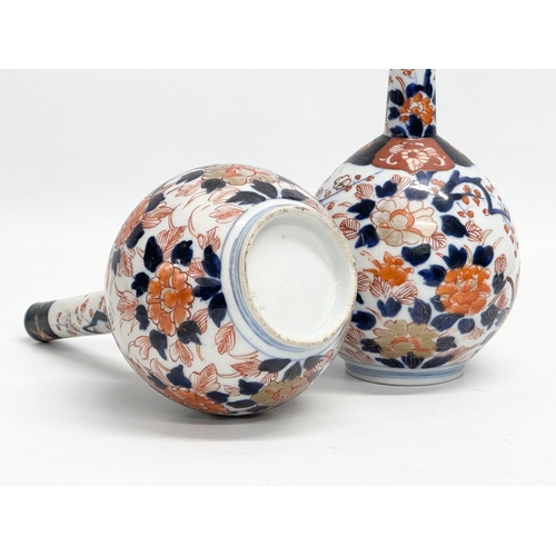 252 - A pair of late 19th century Japanese Meiji period Imari bottle vases. Circa 1880-1890. 20cm