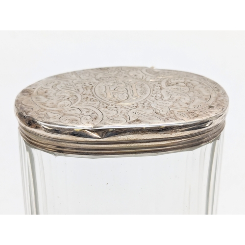 619 - A 19th century silver lidded vanity jar by Moritz Wolfsky. London, 1883. Lid weighs 17.8g. 7x8.5cm