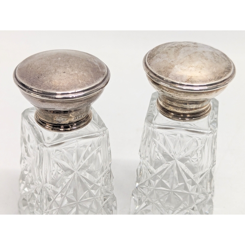 622 - A pair of early 20th century cut glass vanity jars with silver lids by Burtons & Waters. Birmingham,... 