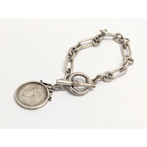 633 - A silver 1918 George V One Shilling coin and toggle and later silver bracelet. Bracelet is London, 1... 