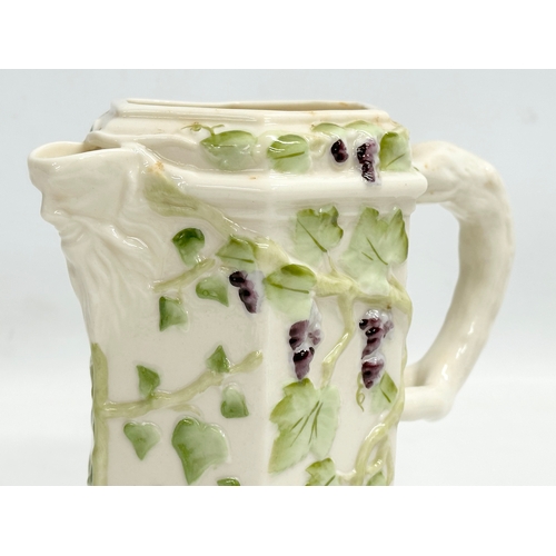 300 - A 4th period Belleek pottery ‘Bacchus’ jug with grape vines and leaves. Early/mid 20th century. 17x9... 