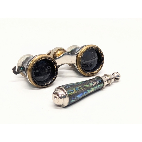 670 - A pair of vintage abalone opera glasses with extending handle in case.