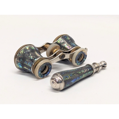 670 - A pair of vintage abalone opera glasses with extending handle in case.