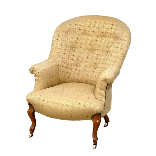 919 - A Victorian walnut buttoned back armchair on Cabriole legs, circa 1870. 66x74x91cm