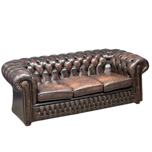 924 - A deep buttoned leather 3 seater sofa. 211cm