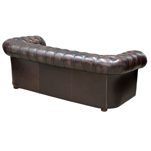 924 - A deep buttoned leather 3 seater sofa. 211cm