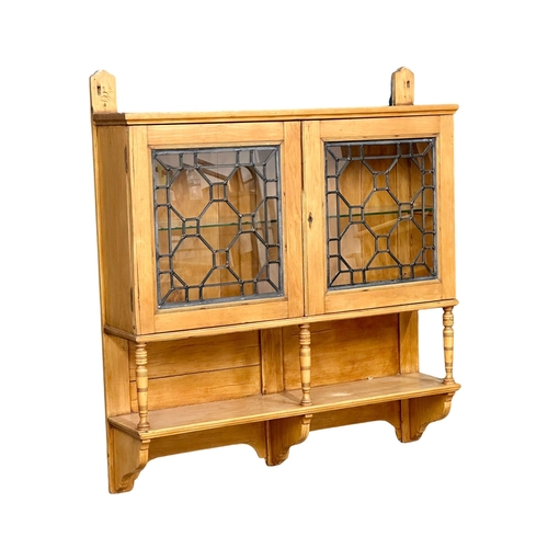 929 - A late 19th century pine wall hanging cabinet with lead astragal glazed doors. Circa 1890. 92x21x101... 