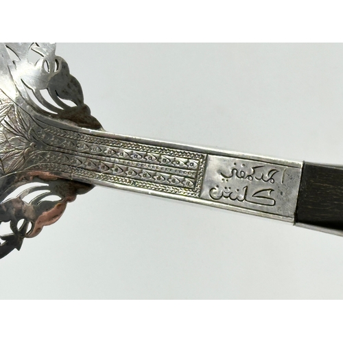 337 - Malaysian silver. A pair of late 19th/early 20th century Malaysian silver serving tools with horn ha... 