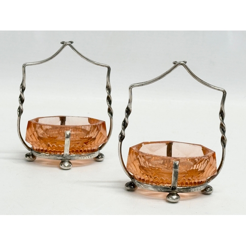 341 - A pair of Victorian cut glass and silver plated salts with matching knife rests.