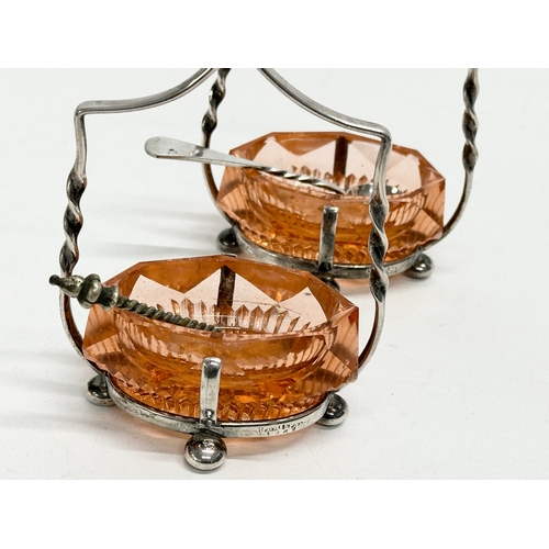 341 - A pair of Victorian cut glass and silver plated salts with matching knife rests.