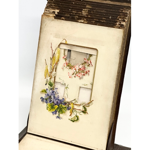 345 - A Victorian leather and hand painted photo album. 26x13x38cm