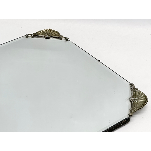 356C - An early 20th century bevelled mirror. 69x41cm S