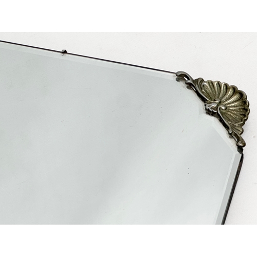 356C - An early 20th century bevelled mirror. 69x41cm S