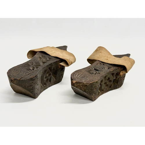 356E - A pair of late 19th century Far Eastern Burmese clogs. 24x9x6.5cm