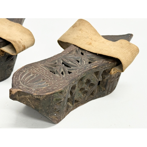 356E - A pair of late 19th century Far Eastern Burmese clogs. 24x9x6.5cm