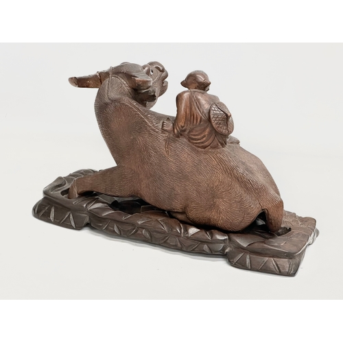 317 - A pair of early 20th century Chinese carved Water Buffalo’s with riders on stands. 26x12x16cm