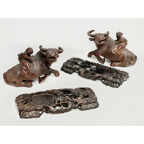 317 - A pair of early 20th century Chinese carved Water Buffalo’s with riders on stands. 26x12x16cm