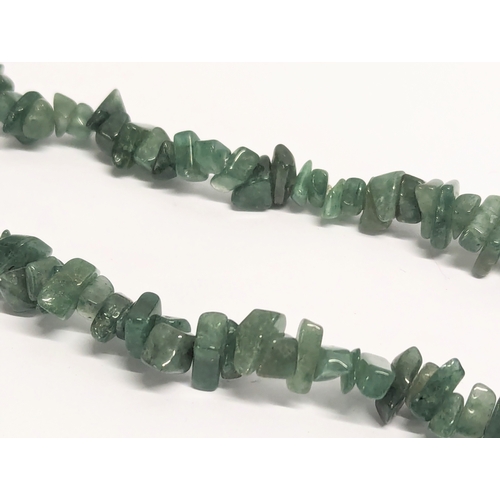 643J - A large jade necklace with a vintage Irish Celtic brooch stamped Miracle.