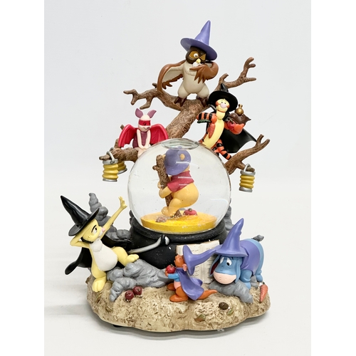 710 - A Disney Store Exclusive ‘Winnie the Pooh’ musical snow globe with box. Snow globe measures 20x27cm.... 