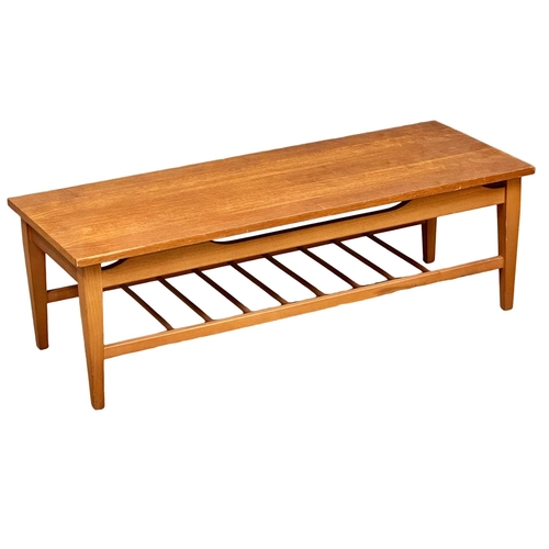 935 - A Mid Century teak coffee table. 115x44.5x37.5cm