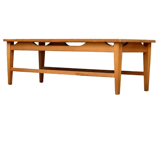 935 - A Mid Century teak coffee table. 115x44.5x37.5cm