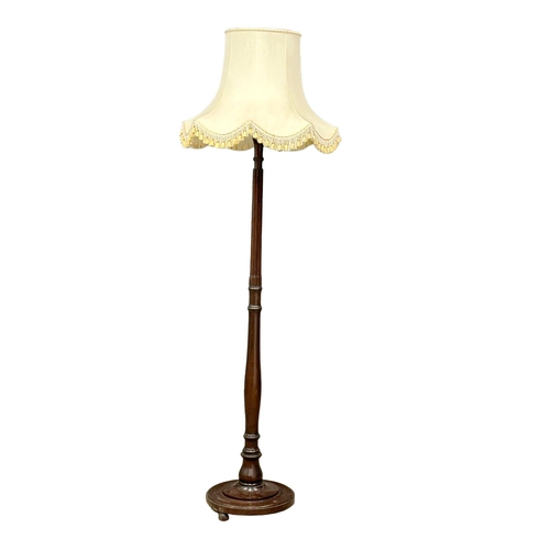 1173 - A vintage Mahogany standard lamp.