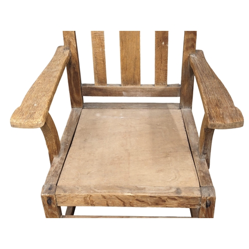 1182 - An early 20th Century Oak armchair