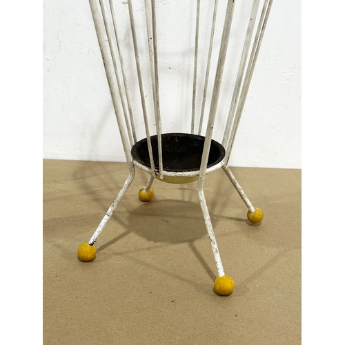 24 - A Mid Century umbrella stand/stick stand and a magazine rack.