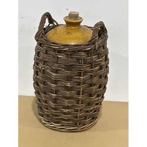 28 - A vintage stone jar in wicker. A.W. Buchan & Co. Portobello. 24x23x40cm